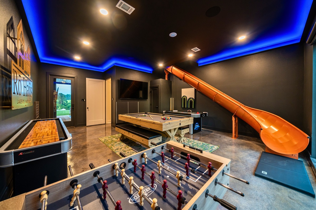 Game on! Our rec room is packed with fun for everyone, featuring a foosball table, pool table, and even a slide for endless entertainment.
