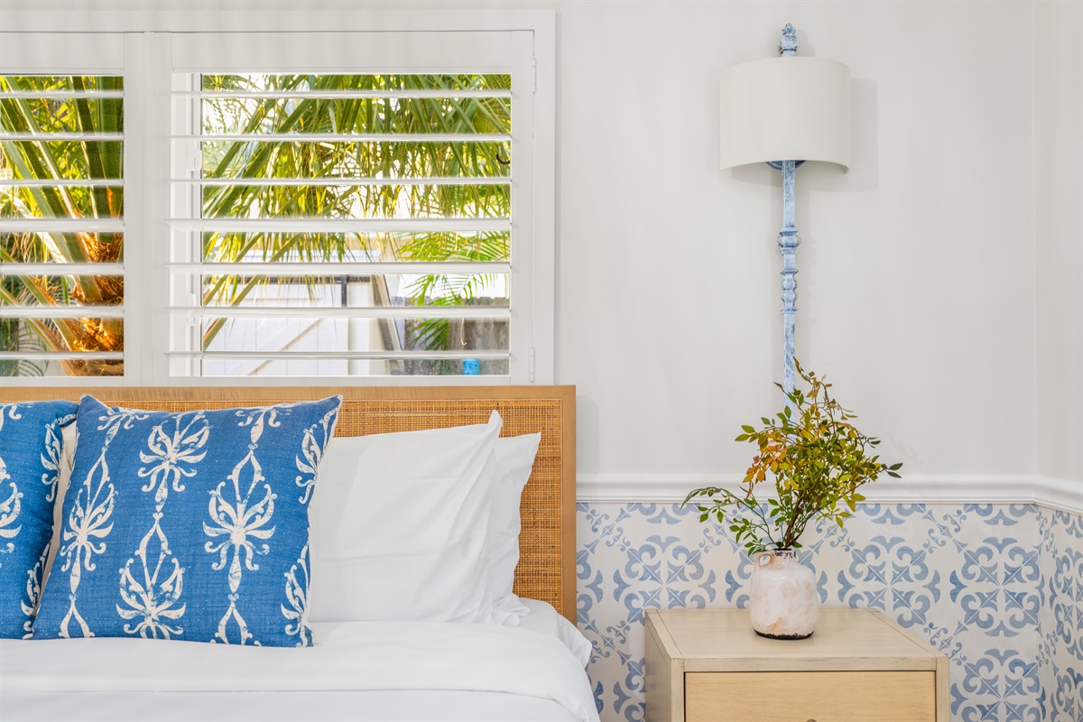 Elegant accents and coastal wallpaper create a serene atmosphere.