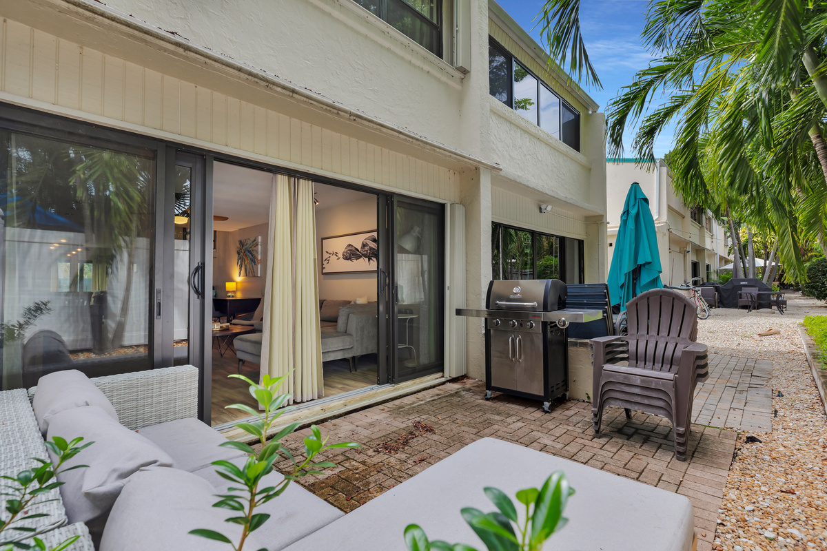 Private patio off living room with seating & propane grill
