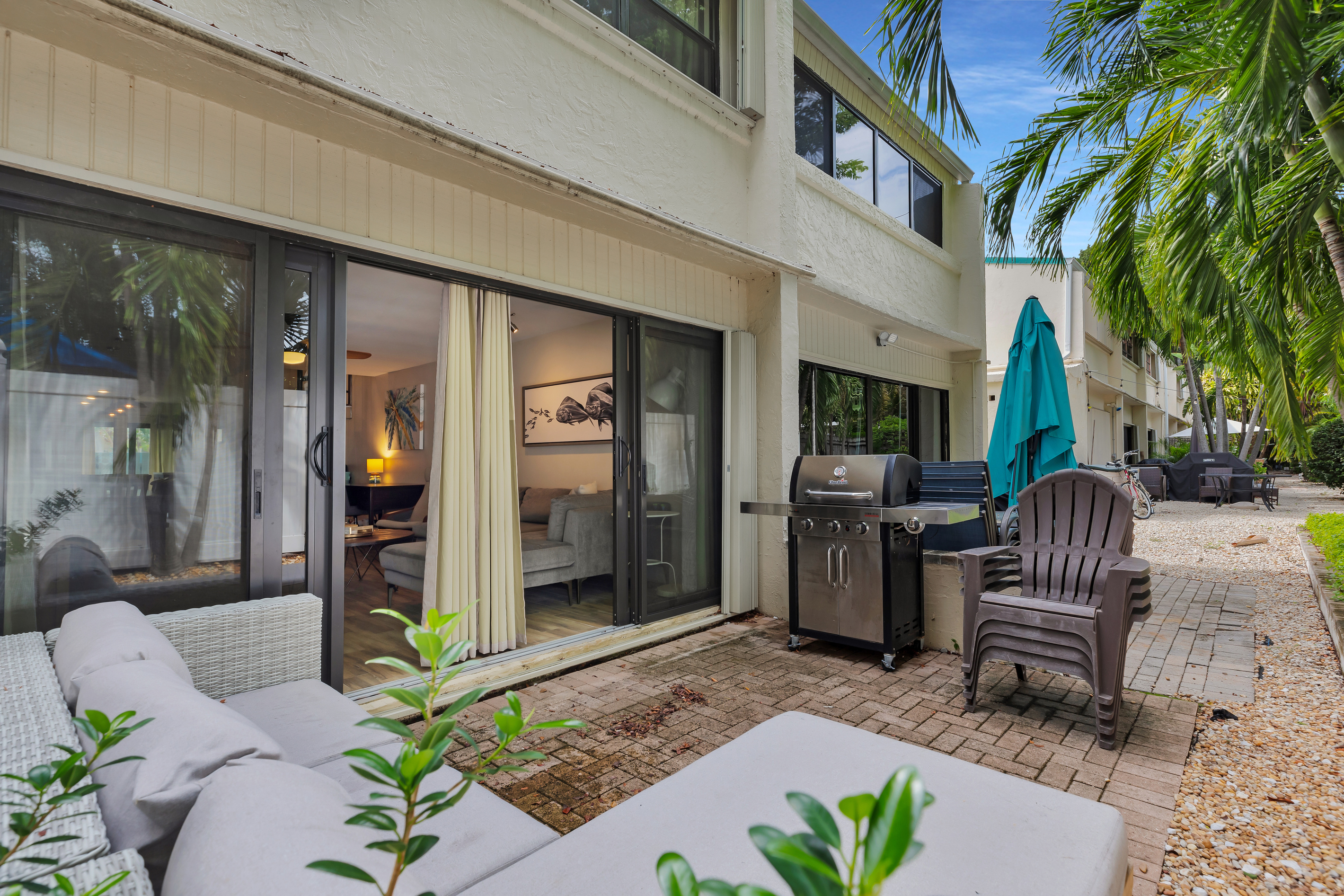Private patio off living room with seating & propane grill