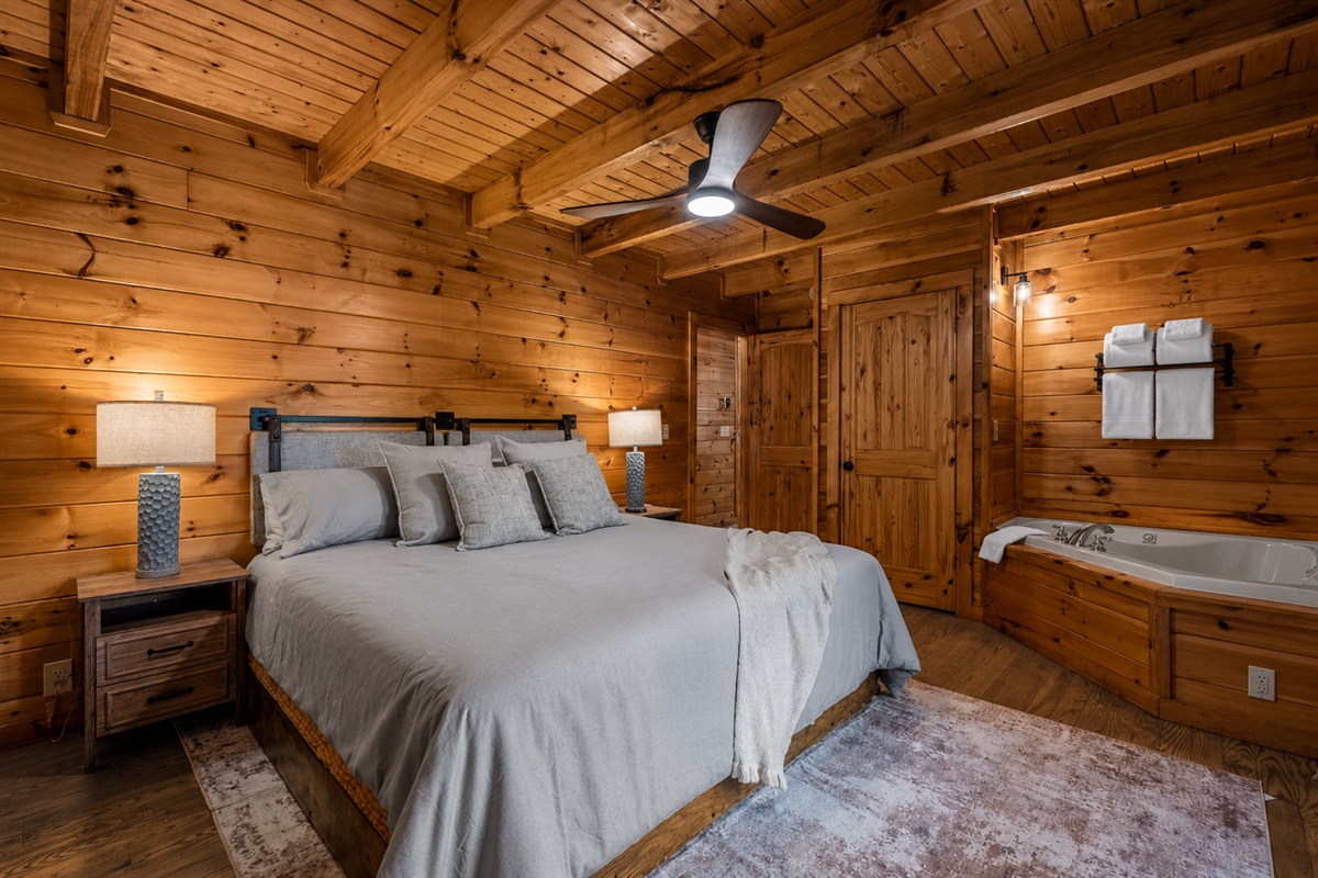 The main floor king suite combines comfort and convenience, featuring a plush king bed and a jetted tub that creates a spa-like retreat within your own space.
