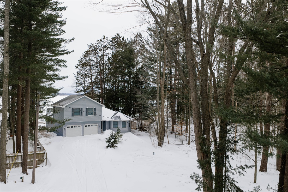 Winter exterior of the home with private driveway