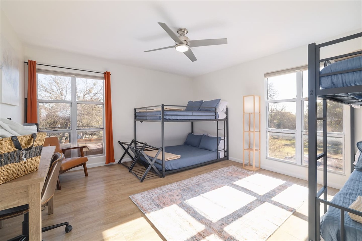 Filled with natural light and flexible sleeping space, this upstairs bunk room is perfect for families, kids, or group getaways. Large windows and cozy touches create a bright, relaxing place to recharge together.