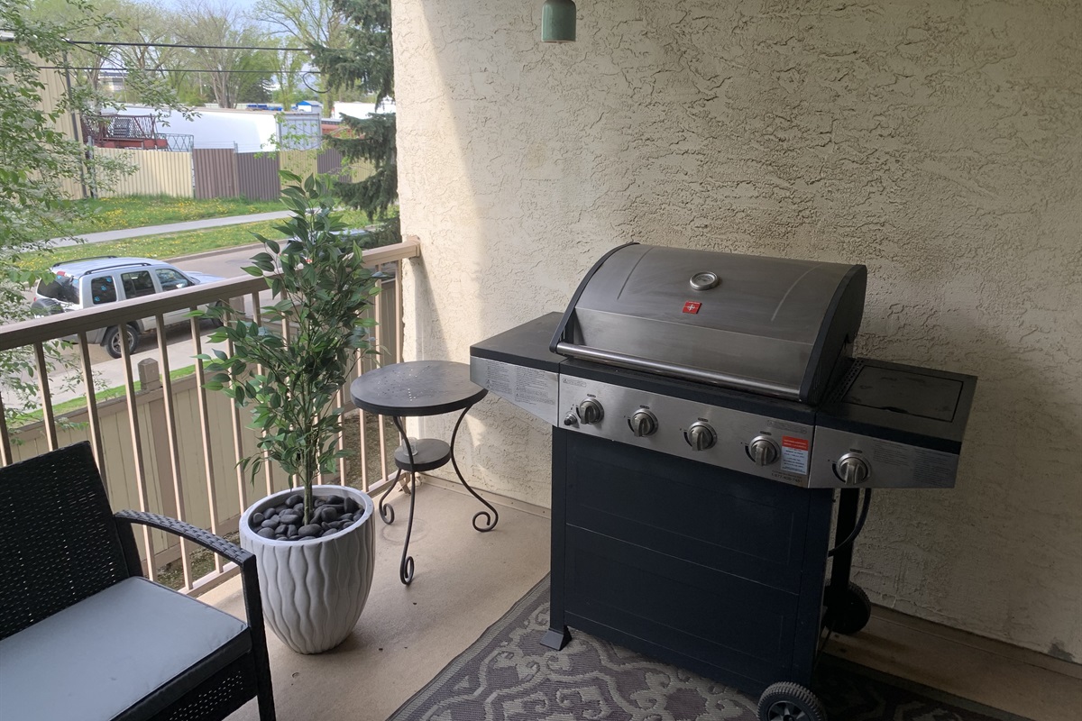 BBQ with cooking utensils.