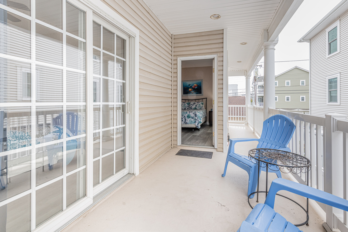 Private Deck Area with Sliding Door Access and Blue Patio Seating