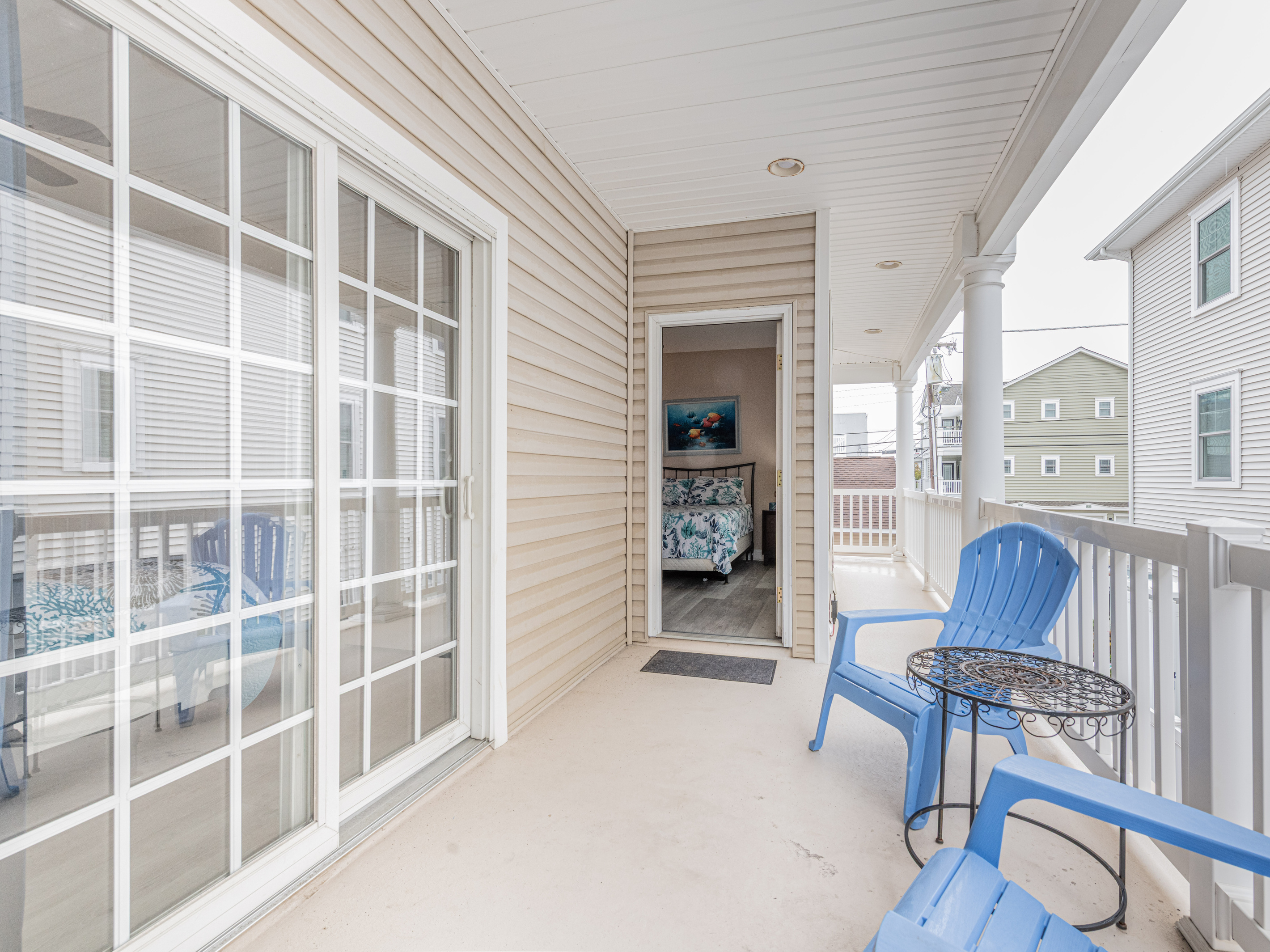 Private Deck Area with Sliding Door Access and Blue Patio Seating