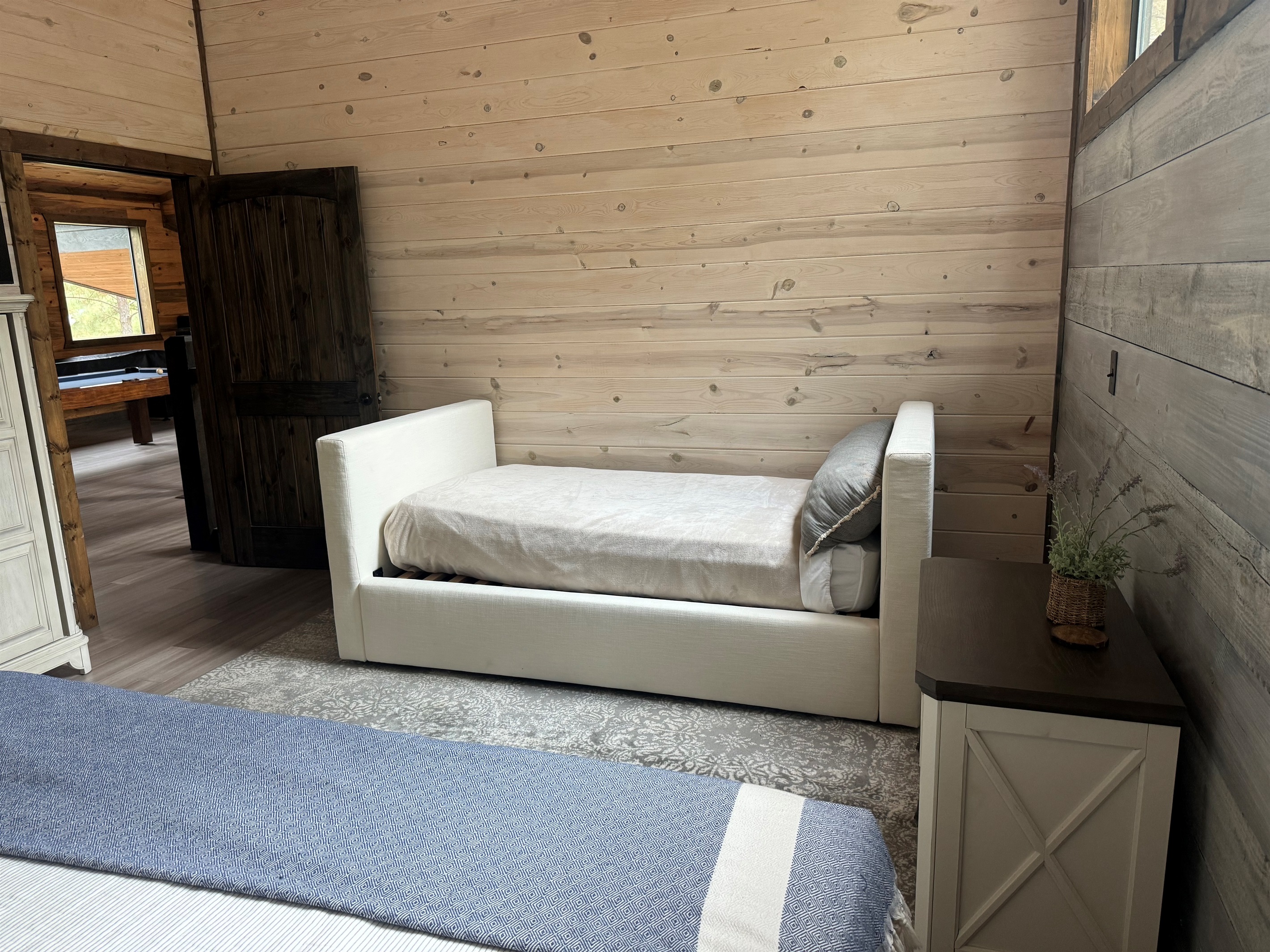 Nestled in the same room as the queen bed, this single bed offers a comfortable and private sleeping spot, ideal for kids or an extra guest.