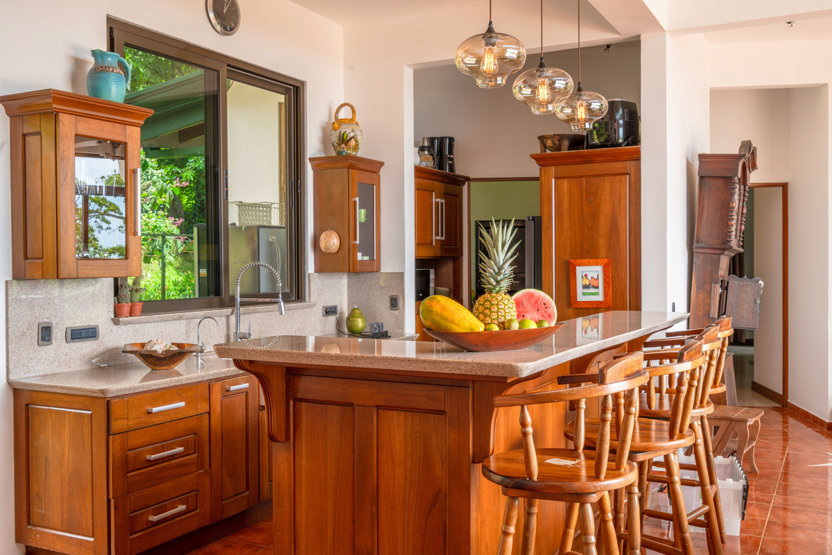 Chef's kitchen with premium appliances, generous island, and bar seating