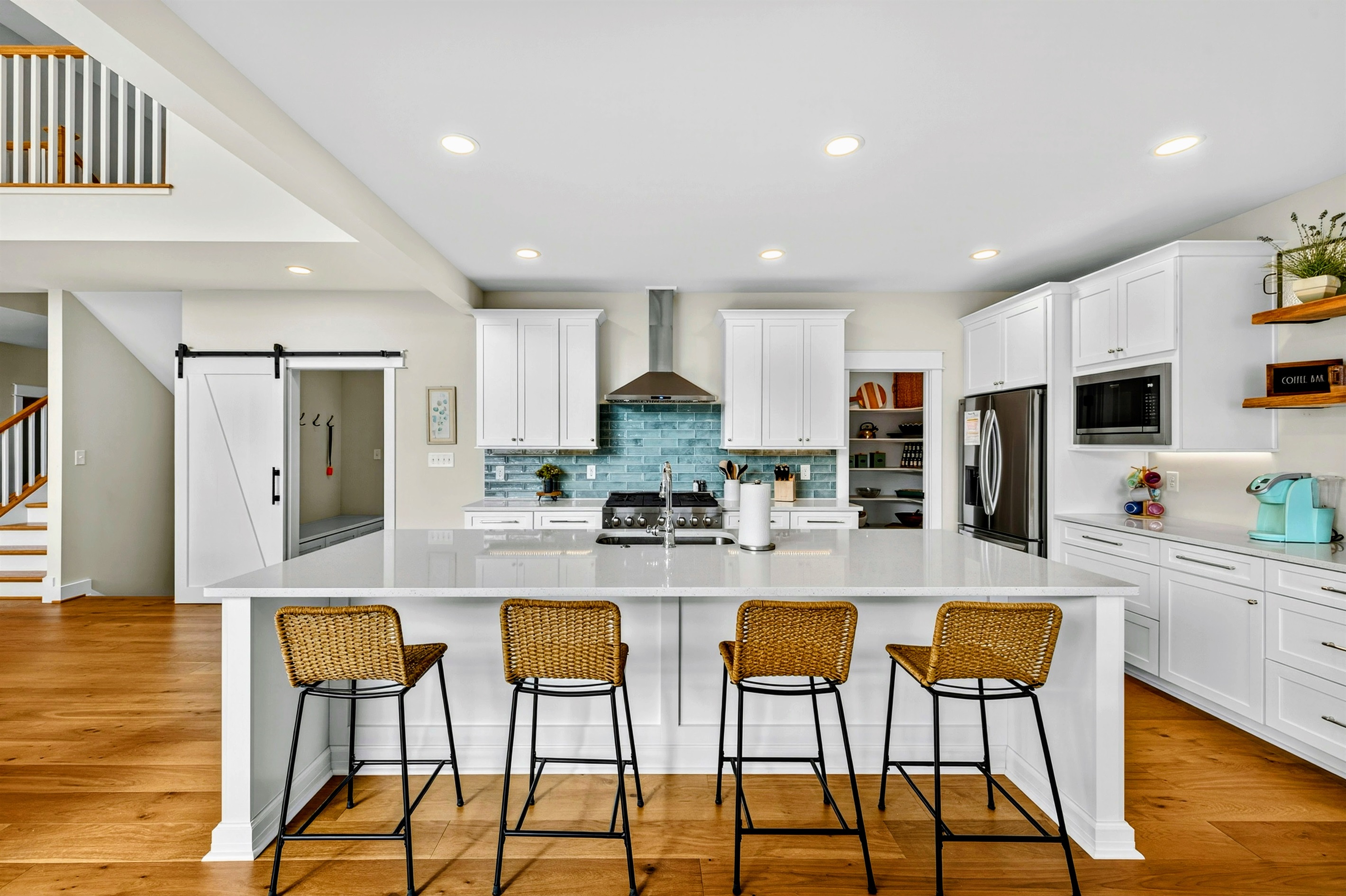 Gorgeous gourmet kitchen with 10 ft quartz island, Restoration Hardware dining table seating 12 and walk-in pantry stocked with all the basics.  Walk out to large screen porch with lake views!