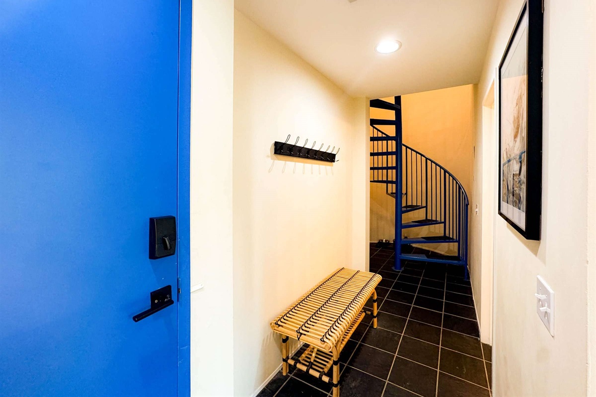 Electronic door code for easy self check-in. The extra tall door is a nice feature of the home as well! The spiral staircase will take you to the two upstairs bedrooms.