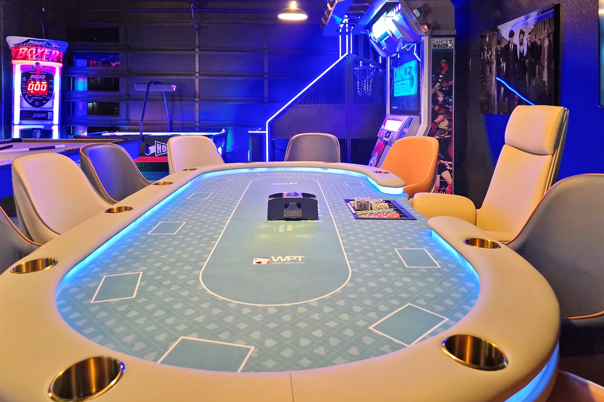 Ultimate game room featuring Vegas style poker table with 10 leather chairs. 
