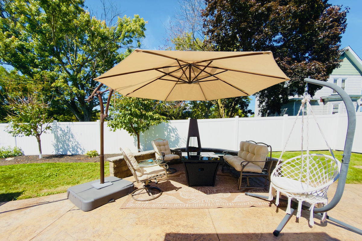 Patio dining and conversation area overlooking the fenced backyard.