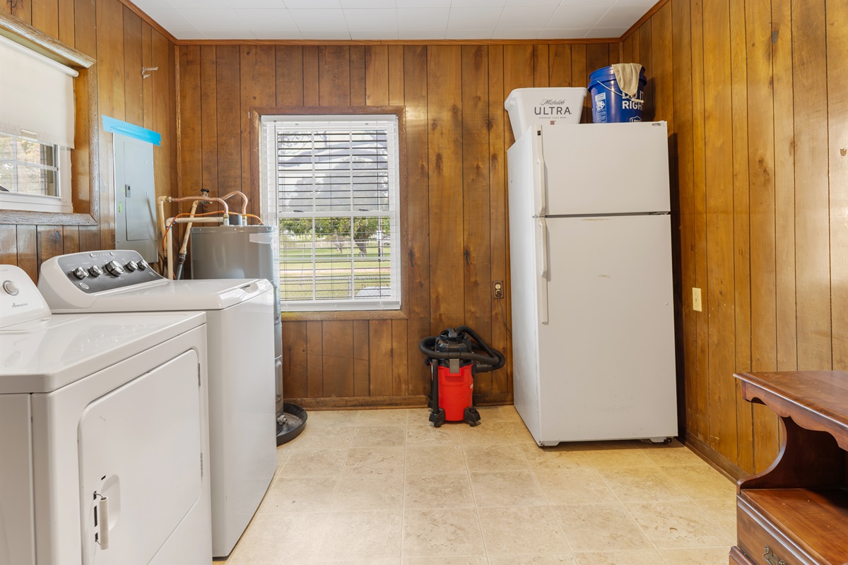 laundry area with extra fridge