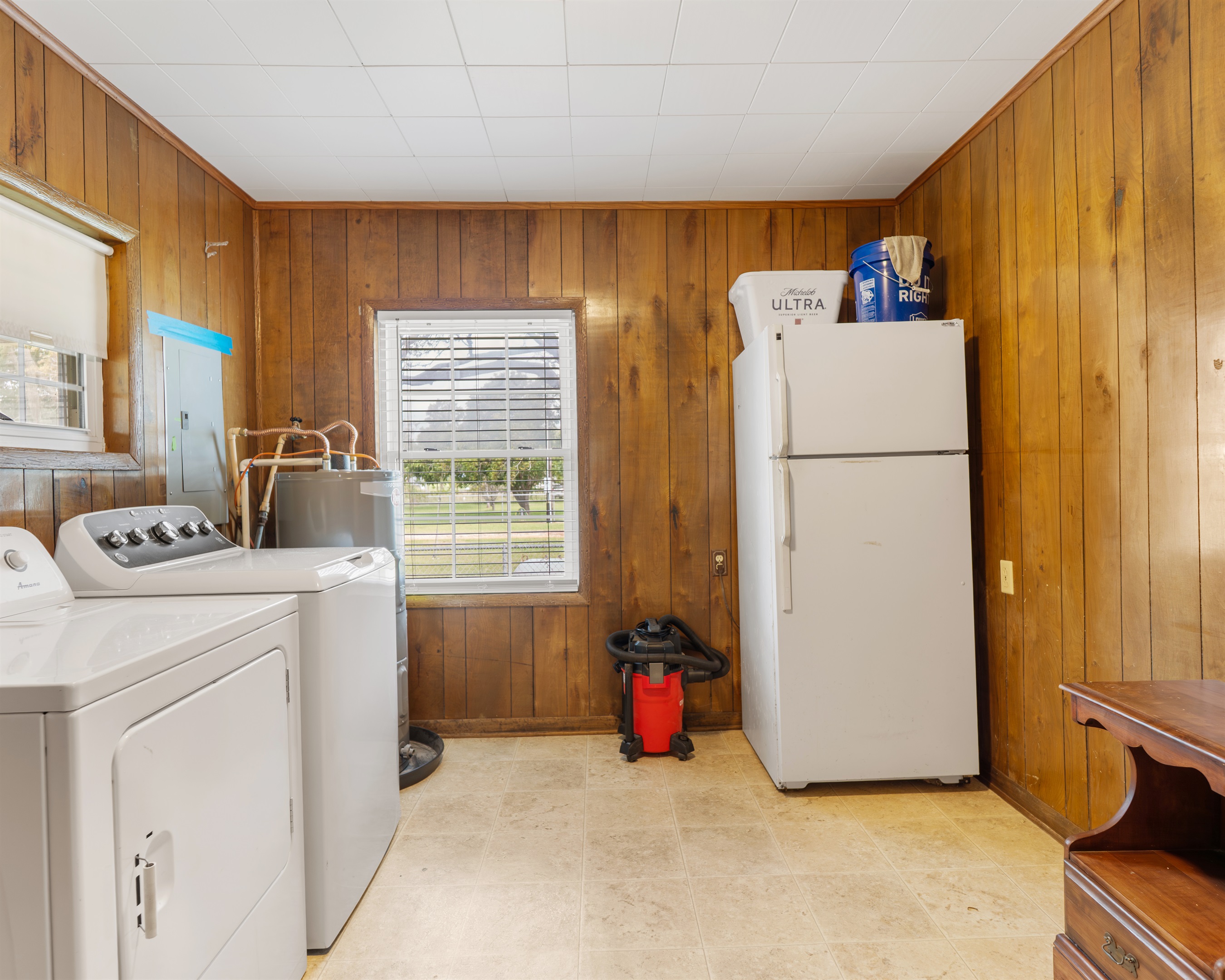 laundry area with extra fridge