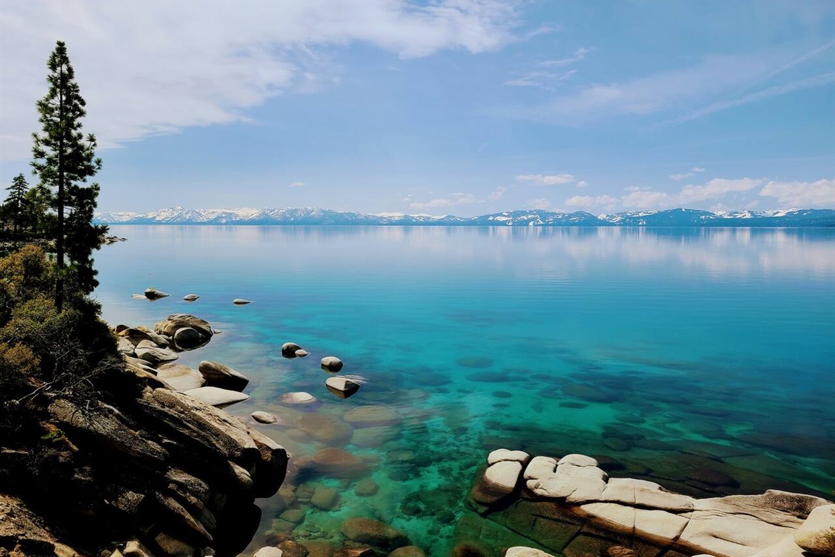 Serene and calm Lake Tahoe in the spring.  The lake is often like this in the AM, and before the wind and the boats.  This is from the bike/walk/jog trail along the lake, just minutes from the cabin.