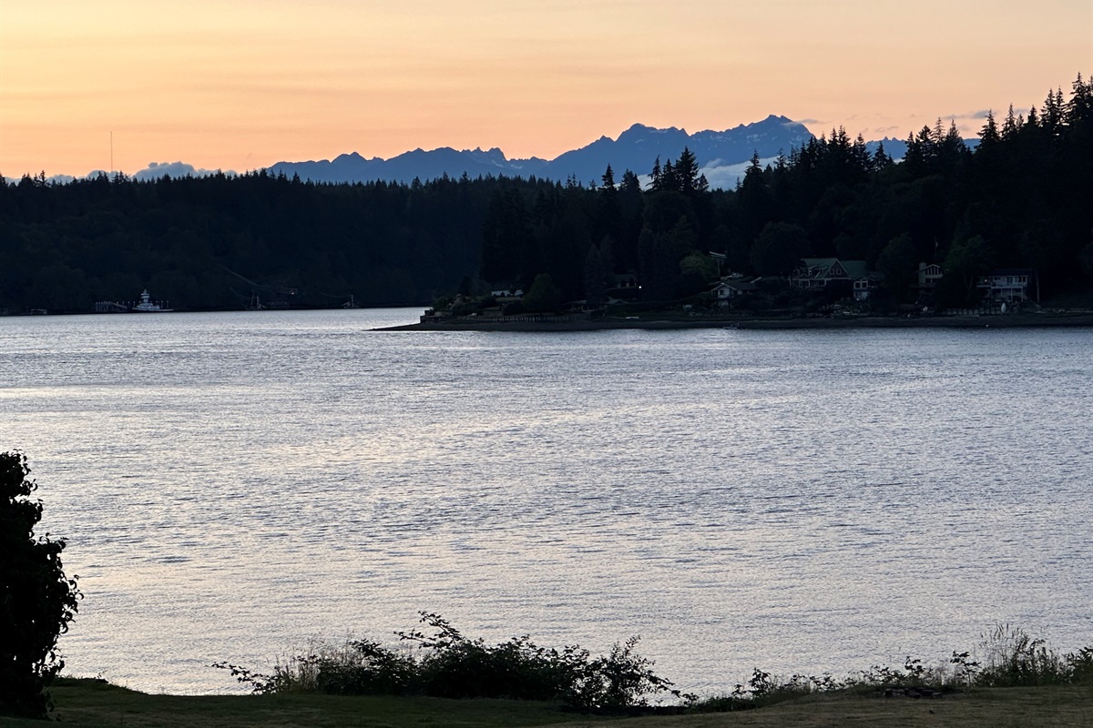 Majestic mountain peaks rise beyond the tranquil waters of Hammersley Inlet —a stunning natural backdrop