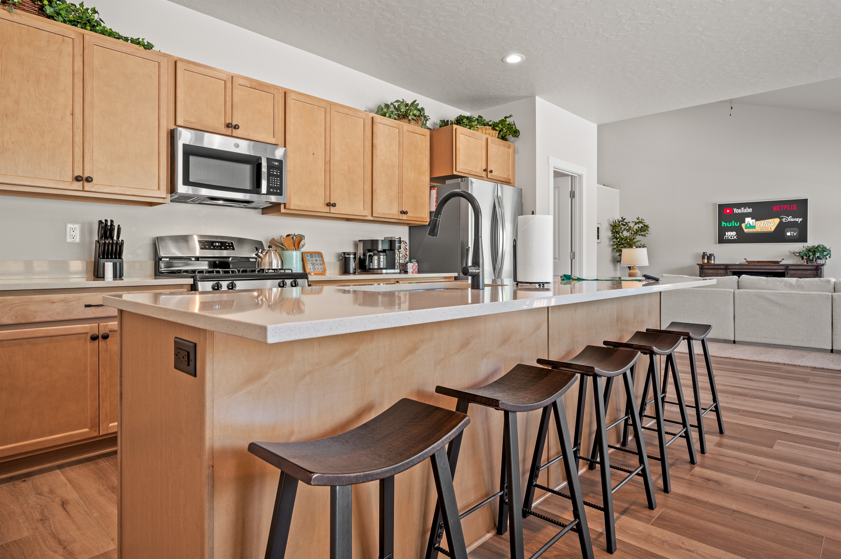 The spacious kitchen island seats five, creating the perfect spot to gather, chat, and watch the chef in action.
