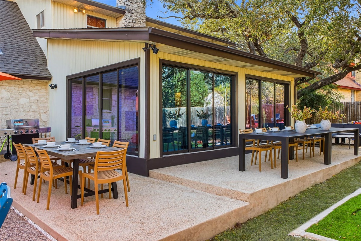 Patio with gas grill and two dining tables seating 14+ guests