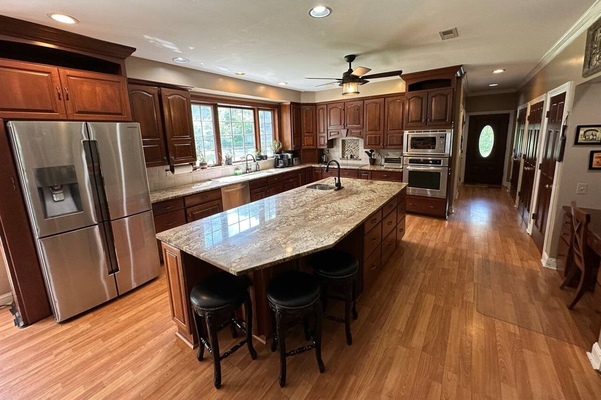 Kitchen with 9 ft ceilings, top quality appliances, 2 sinks, large island, lots of lighting and cabinet space