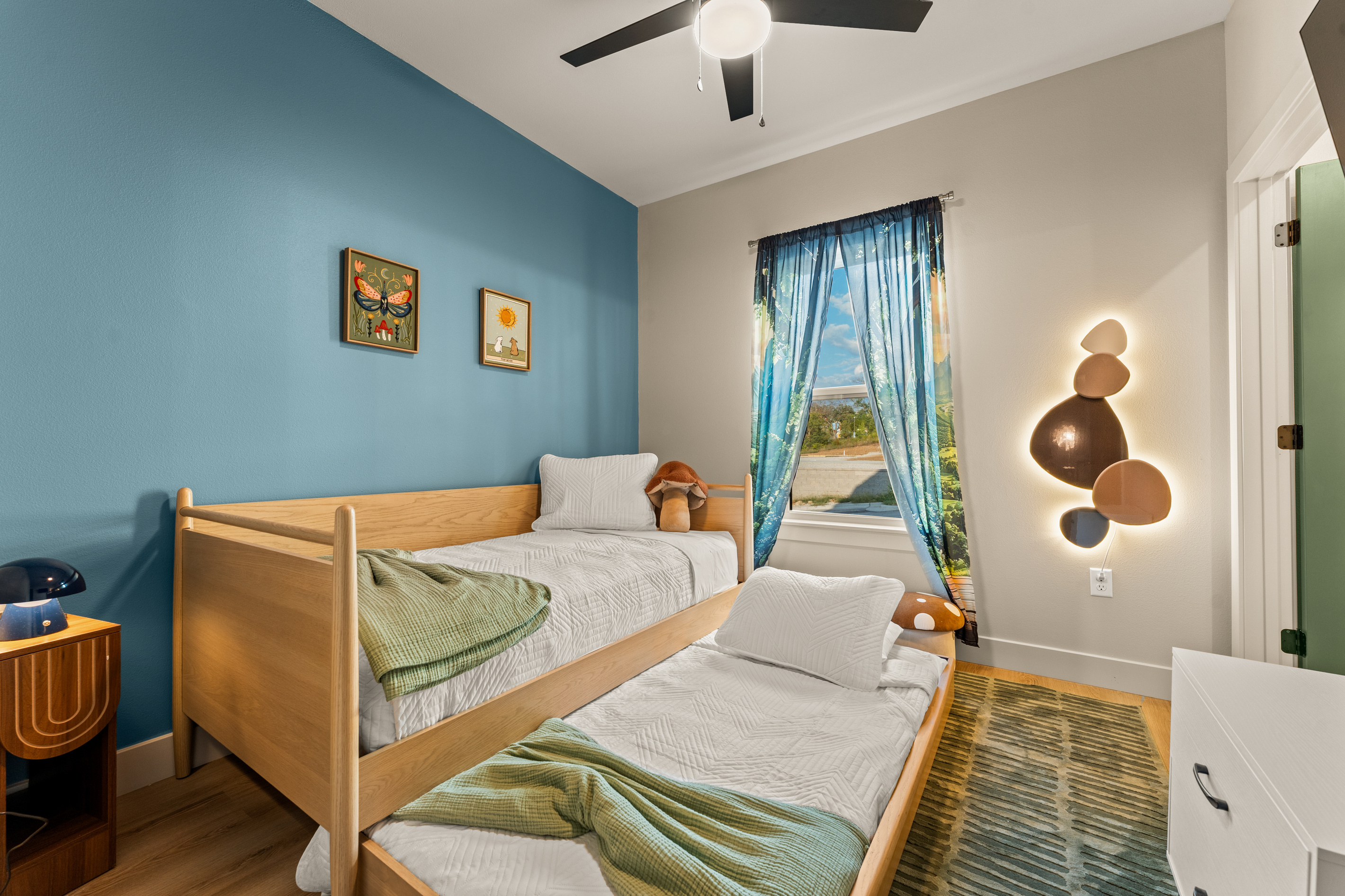 A colorful kids’ room with separate beds gives younger guests their own cheerful space to settle in and recharge.