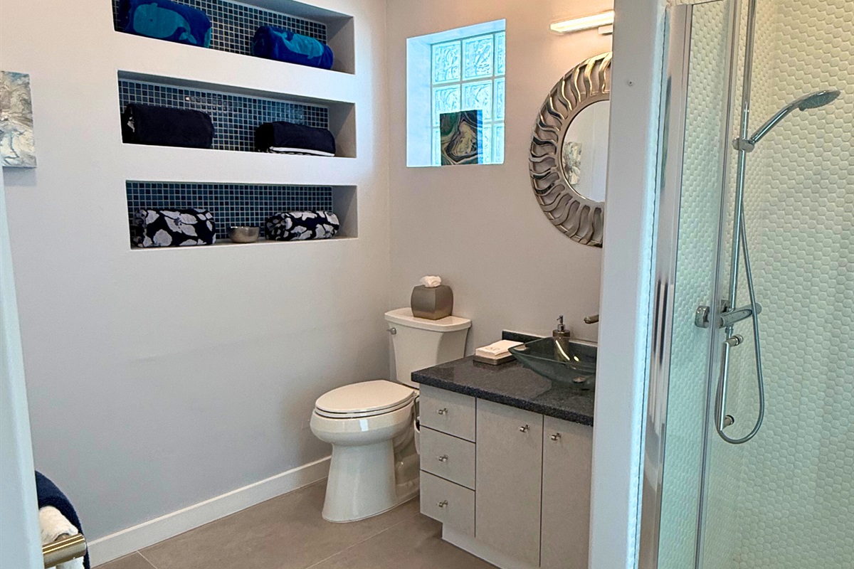 This full bathroom is located off of the pool deck