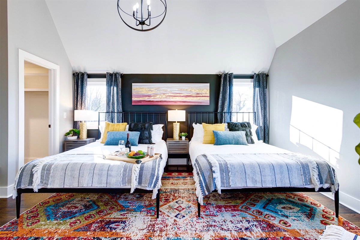 - Bright, bold, and full of personality, this spacious room is perfect for sharing - Twin beds with soft throws, colorful pillows, & a stunning rug that ties it all together - Sunshine, space, & style, ideal for friends, family, or a comfy group getaway