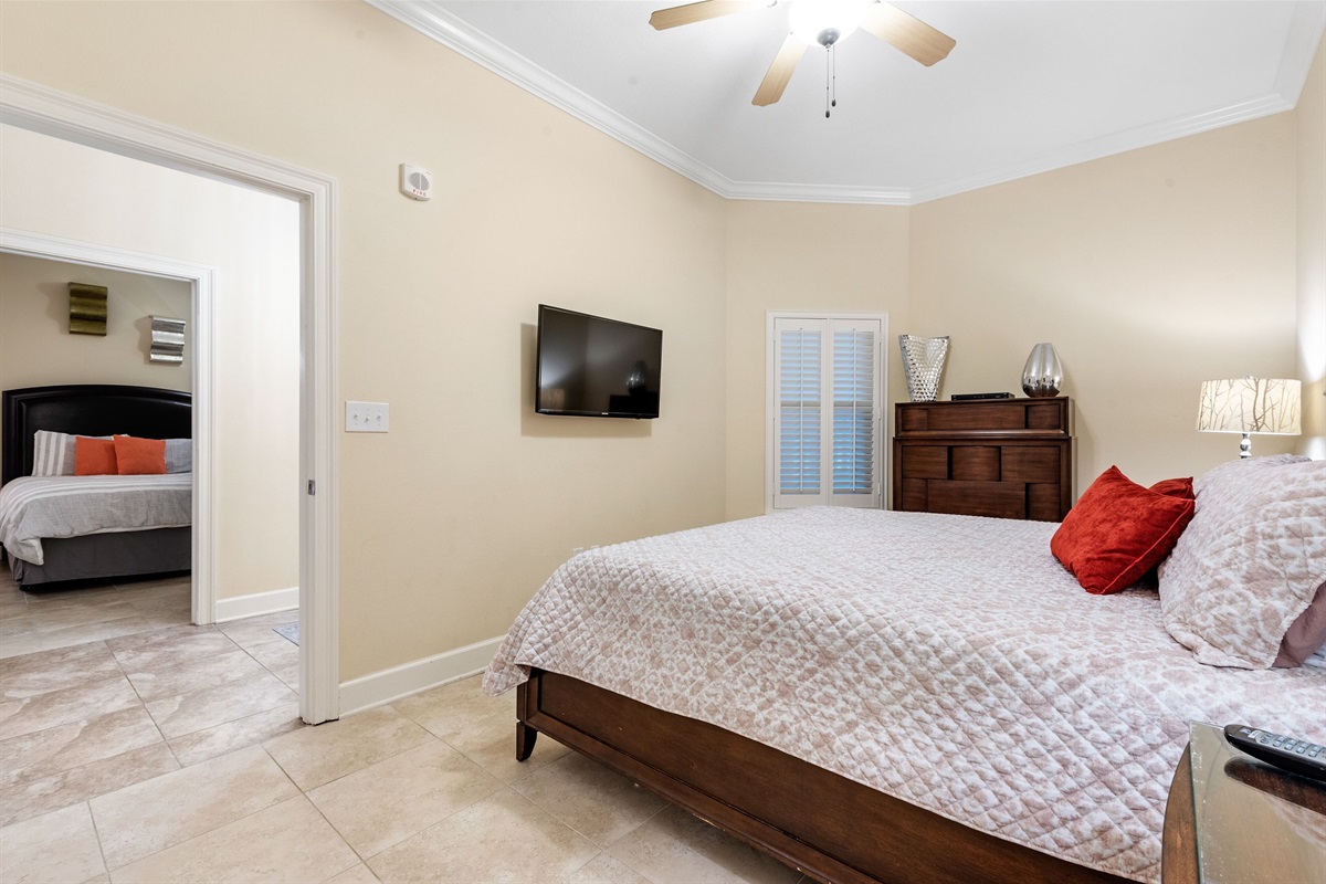 Guest bedroom with king bed, ceiling fan and en-suite bathroom  