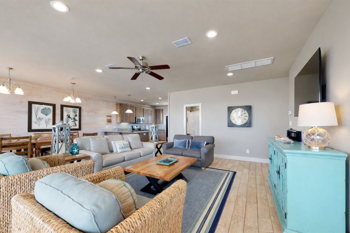 Living room area with plenty of seating and wall mounted Smart TV. Guests must log in to their own streaming services