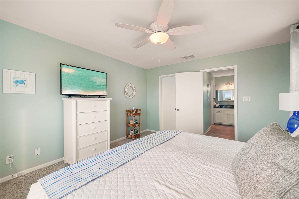 The king master feels like a retreat within a retreat. Iron art, blue accents, and room to unwind after a beach day. Sleeps 6.