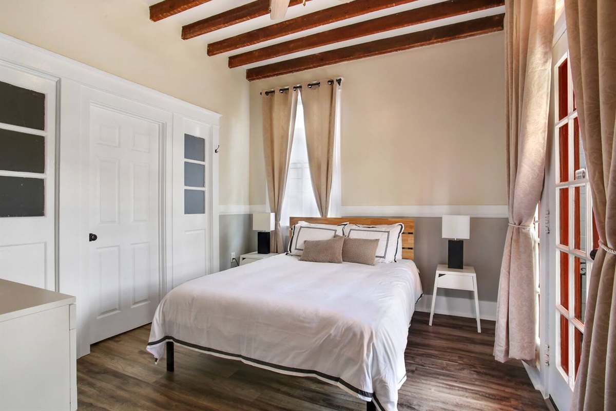 Bedroom 5. 1 king bed, dresser, blackout curtains, connecting door to bedroom 4. Not pictured: Roku TV. (Note: pic is of a queen, but it is now king.)