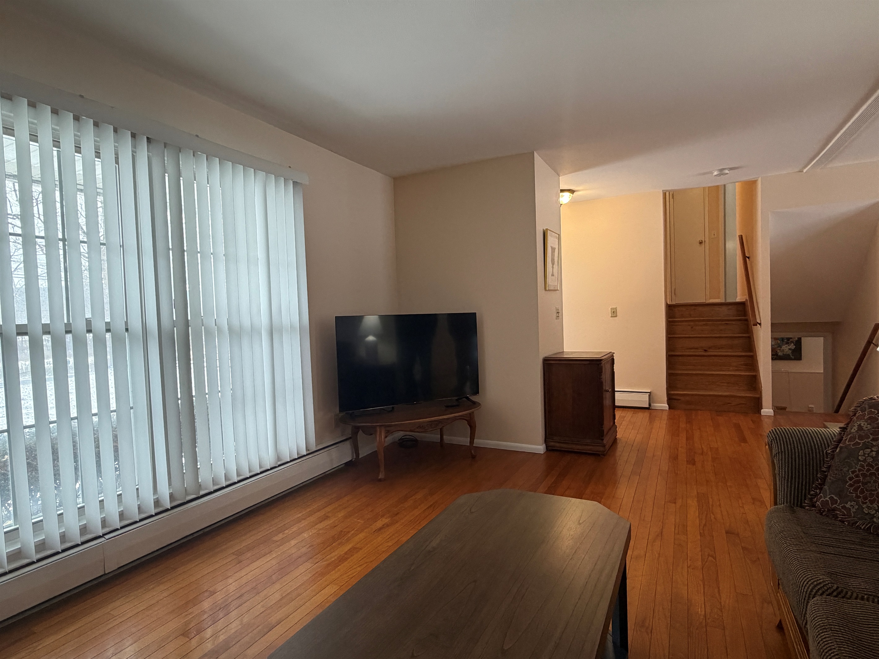 Living room with SmartTV, stairs up and down
