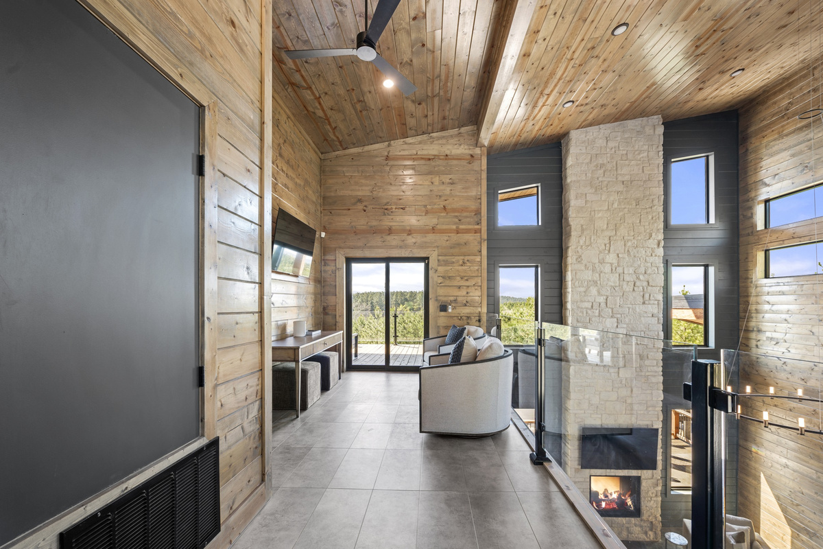 Loft luxury! Elevate your relaxation in our cozy upper loft, where comfort meets style. Snuggle up by the fireplace or bask in the natural light by the windows.