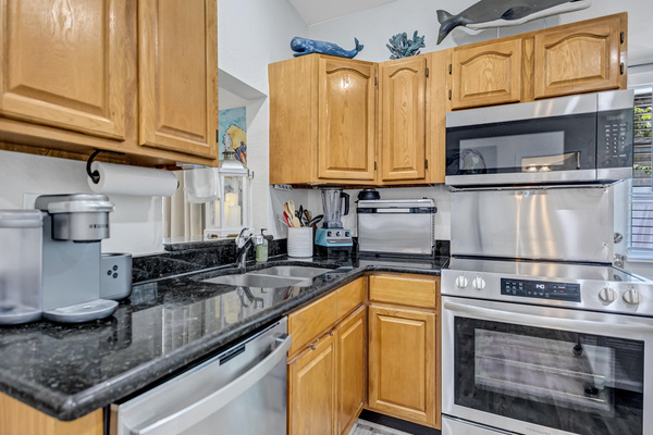 Kitchen with all stainless-steel pots and pans, fiesta ware dinnerware, toaster with air fryer, filtered ice and water and more