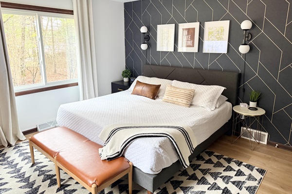 King bedroom with electric fireplace