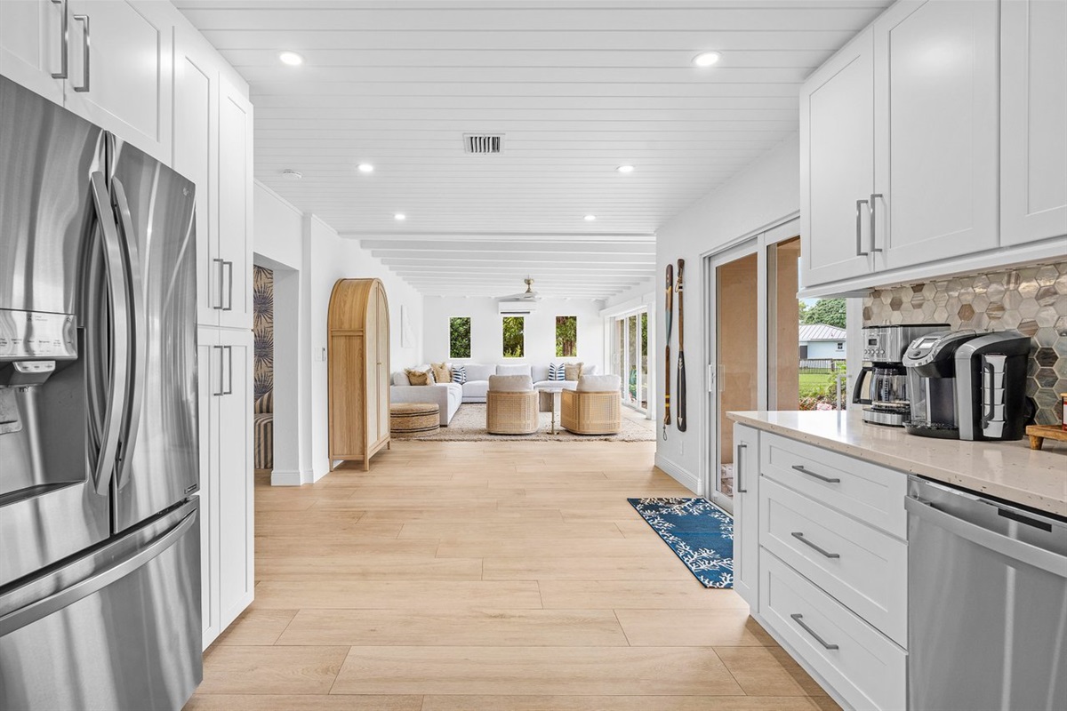Open-concept layout connecting kitchen, dining, and living areas