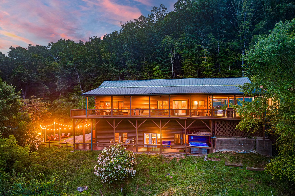 Exterior Oasis: Illuminated by string lights, this retreat blends rustic charm with nature's beauty.