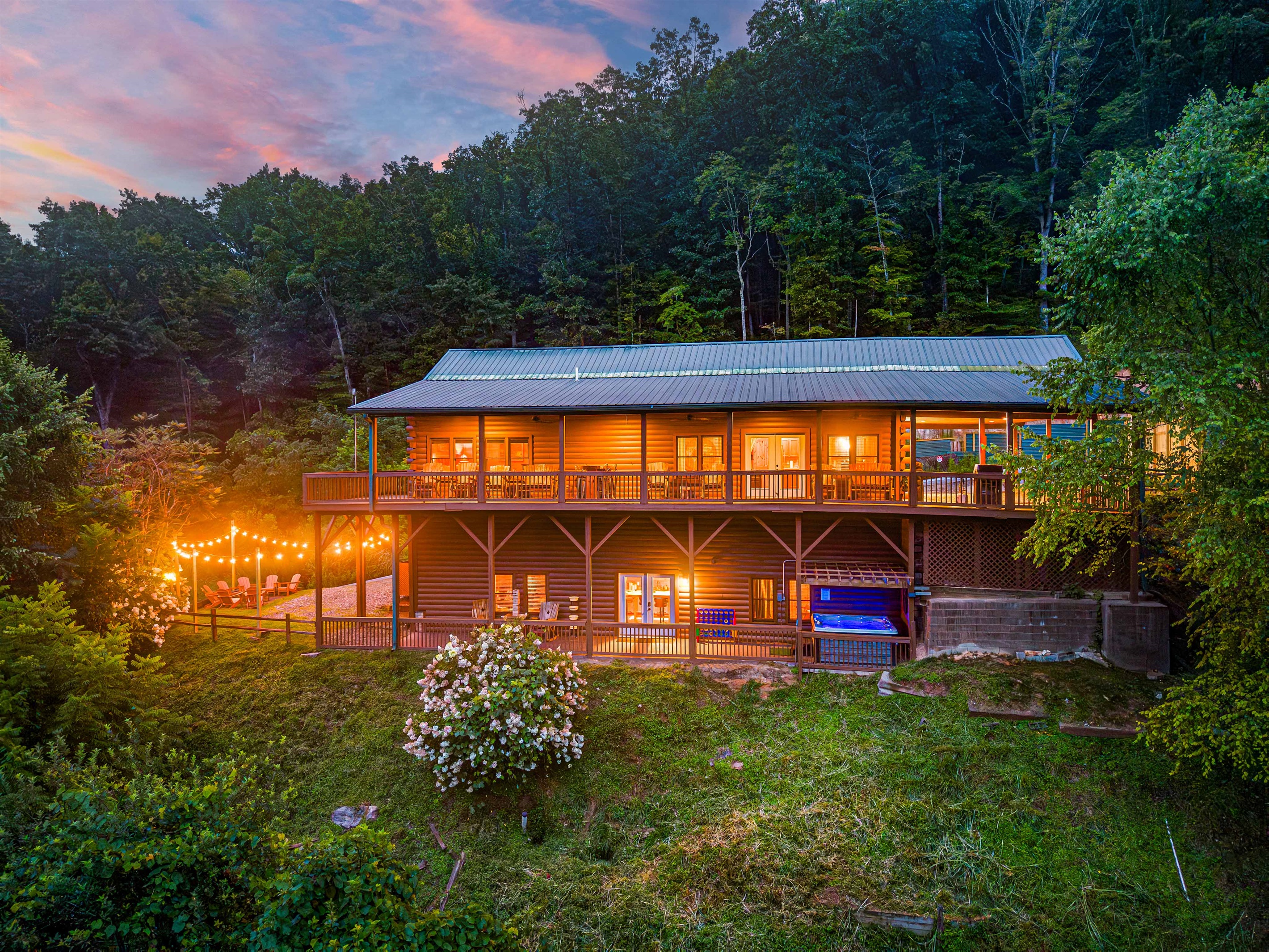 Exterior Oasis: Illuminated by string lights, this retreat blends rustic charm with nature's beauty.