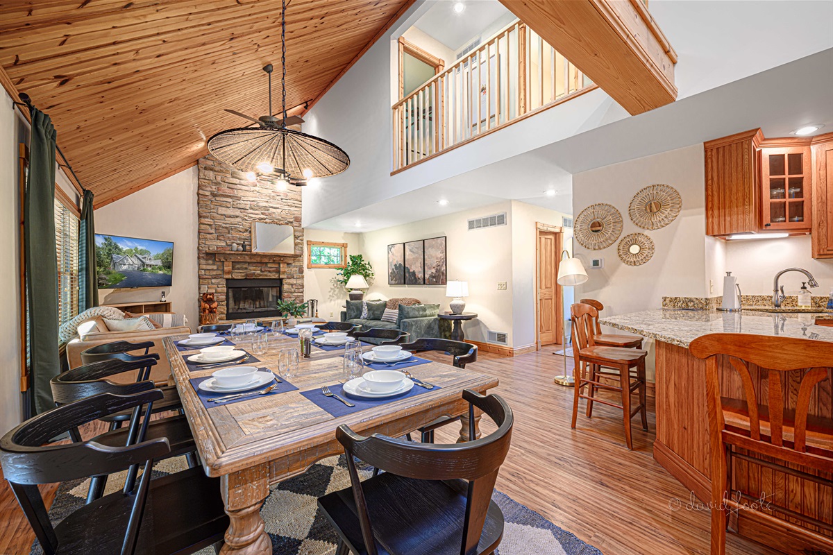 Open kitchen/dining/living room with vaulted ceiling for catching up with family and friends