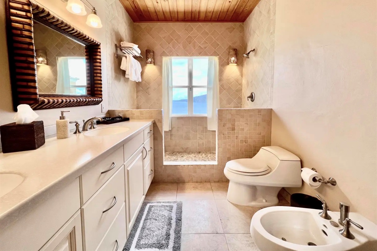 Bright bathroom vanity with plenty of storage, fresh towels, and a large mirror for easy getting ready.
