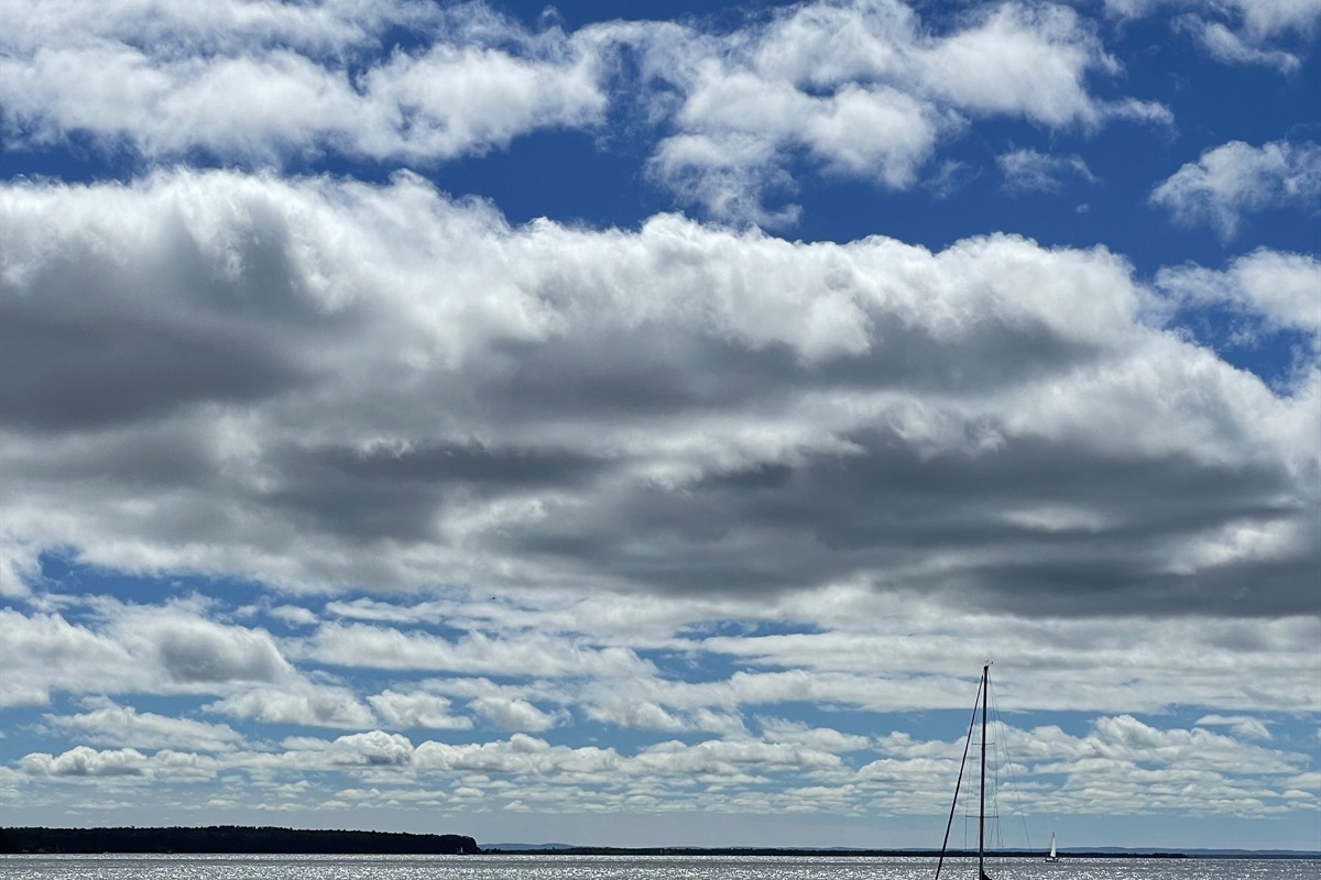 View towards Madeline Island from Bayfield docks - sailboat. Summer