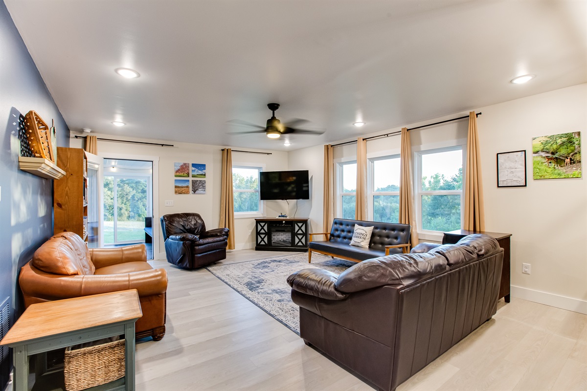 The living room has plenty of space for the whole family! The sunroom is out the door past the bookcase.