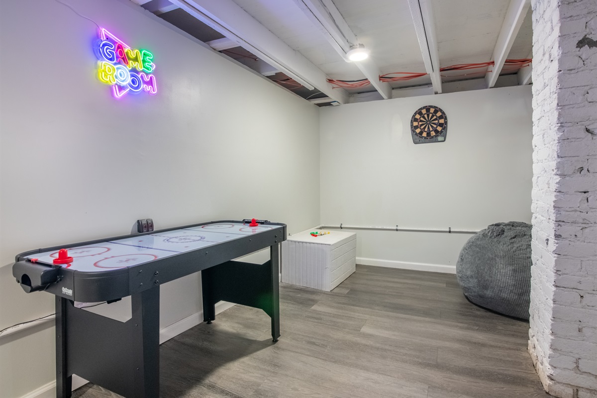 A dedicated game zone featuring air hockey and neon vibes