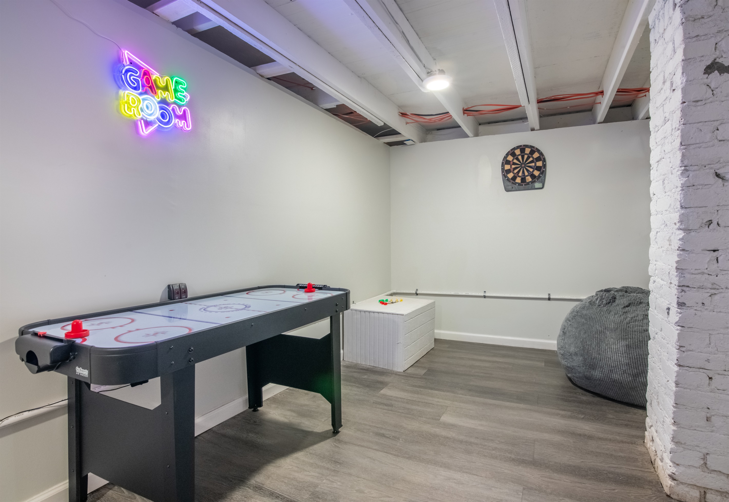 A dedicated game zone featuring air hockey and neon vibes