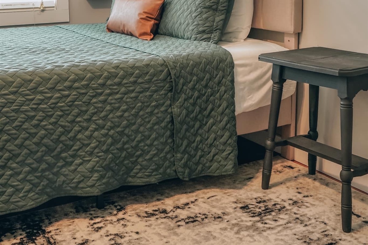 Turn in for the night in this comfy queen size bed. This bedroom is located on the lower level. You will find a dresser and an open wardrobe for hanging clothing. 