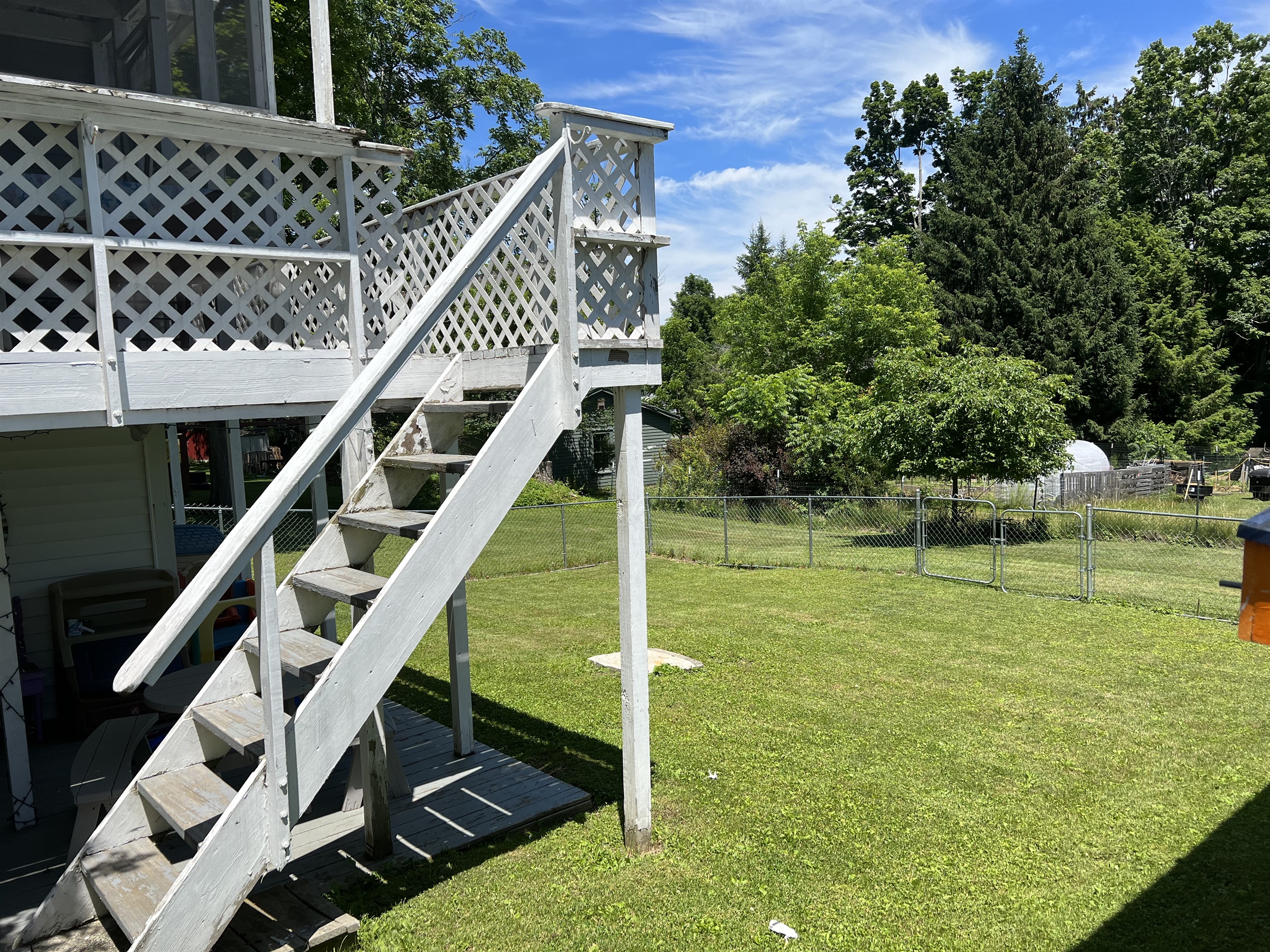 Stairs to rear screened porch, fenced back yard