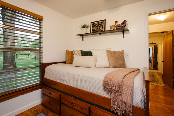 A trundle bed with garden view. 