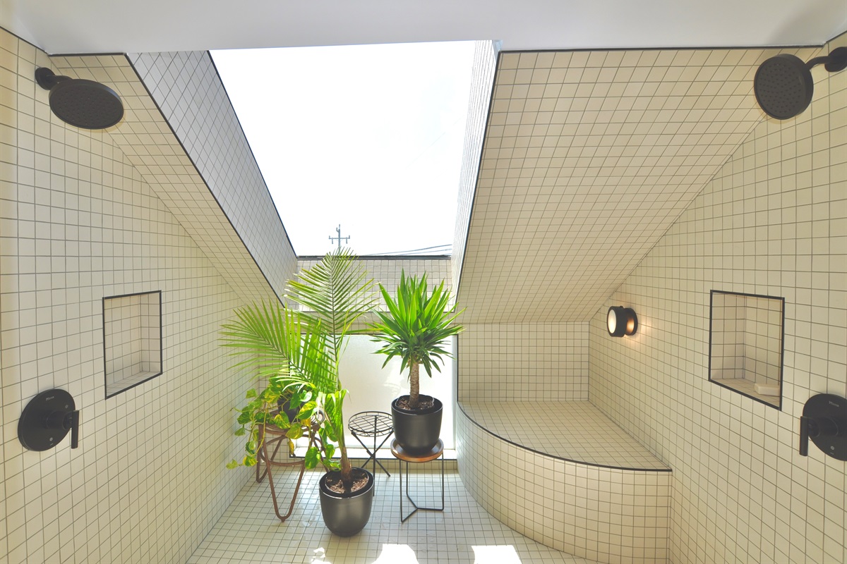 Roomy shower with ocean views and a large skylight.
