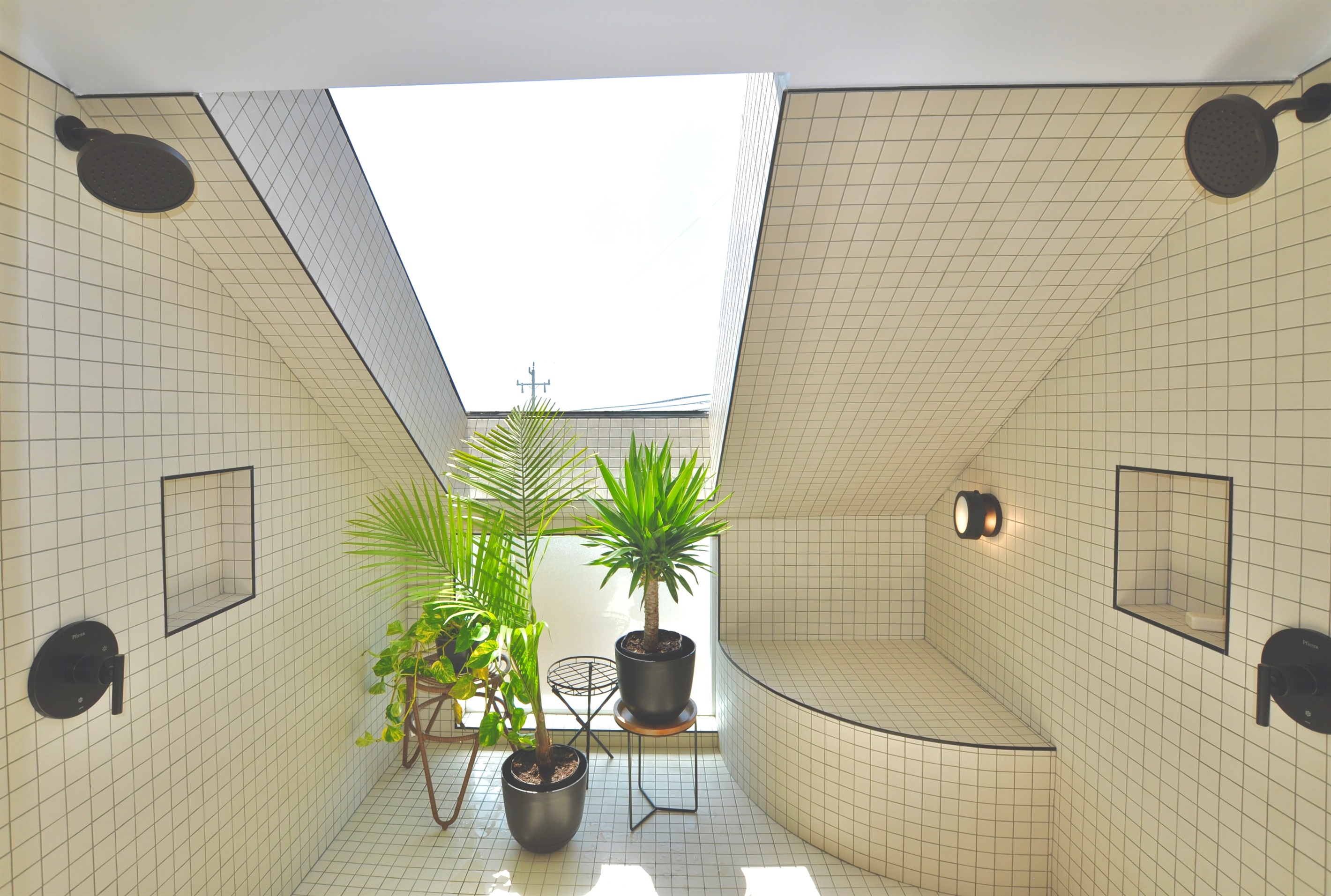 Roomy shower with ocean views and a large skylight.