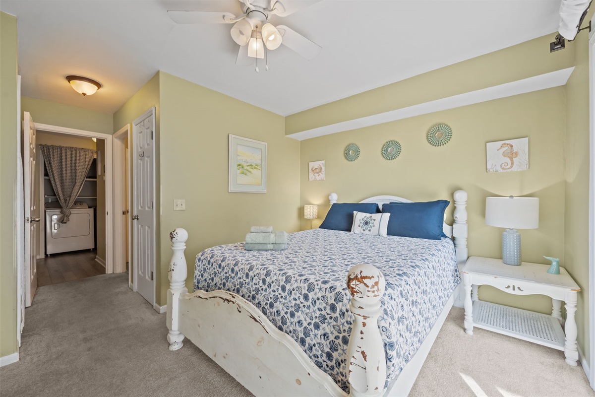 Relaxing queen bedroom with soft lighting and easy access to the ensuite bathroom for added privacy