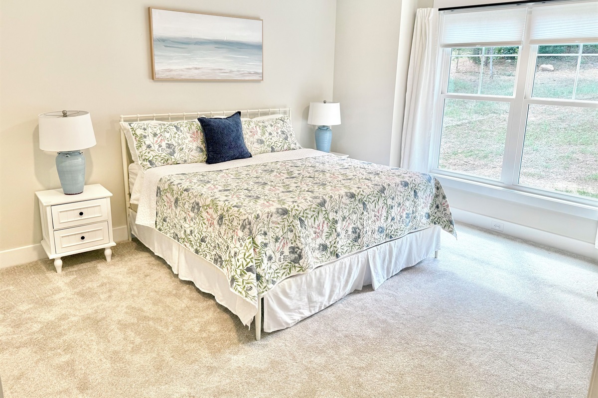 The 2nd main level king suite blends crisp, fun colors with bright, luxurious bedding and a stately antique dresser to add timeless charm to the master suite. We also coordinated the same colors in this master bath to create an inviting retreat.